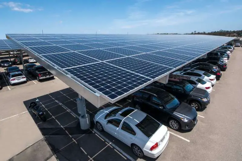 Covering parking lots with Solar Panels, providing Shade, and Generating Electricity to charge Electric cars