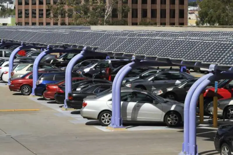 Covering parking lots with Solar Panels, providing Shade, and Generating Electricity to charge Electric cars