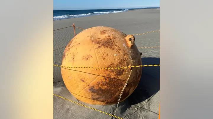 On Tuesday, Japanese officials launched an investigation into a massive, inexplicable metal ball discovered on a beach by a lady. As part of the inquiry, the beach in Hamamatsu was closed to the public.