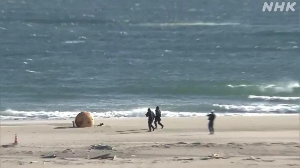 On Tuesday, Japanese officials launched an investigation into a massive, inexplicable metal ball discovered on a beach by a lady. As part of the inquiry, the beach in Hamamatsu was closed to the public.