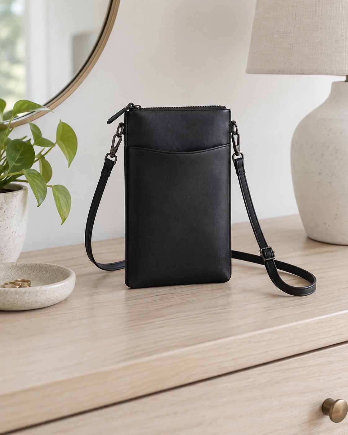 Slim black PU-leather crossbody phone pouch with a top zipper