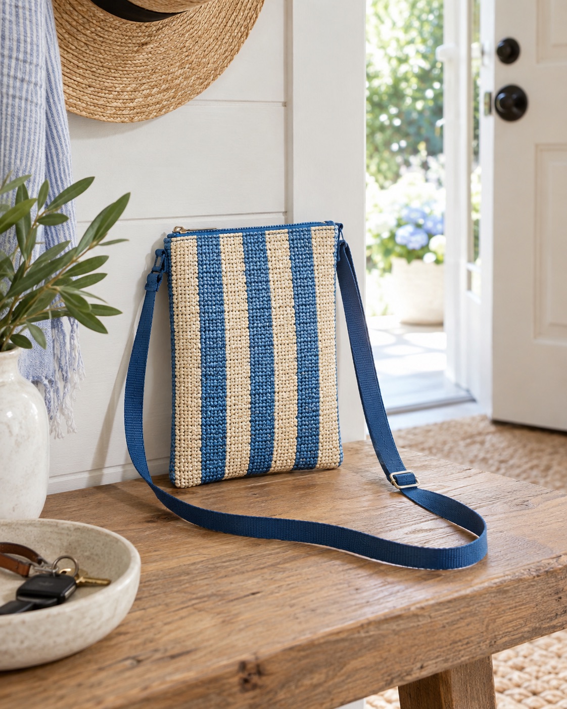 Blue-striped woven crossbody phone pouch with an adjustable strap