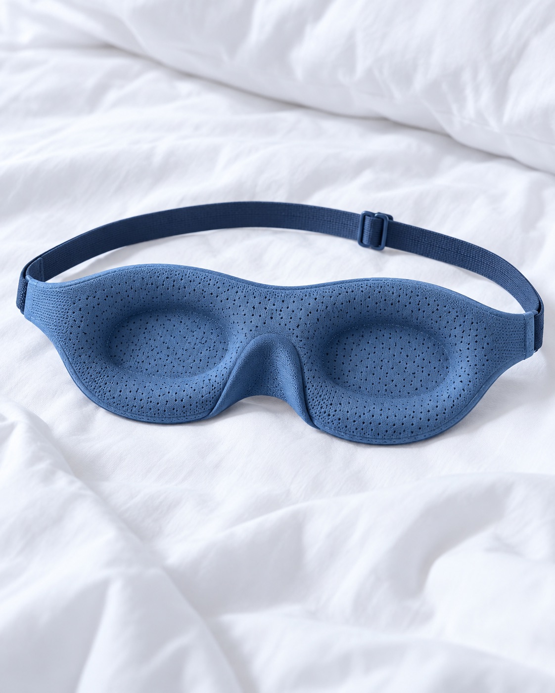 10 Contoured Sleep Masks for Side Sleepers and Bright Bedrooms Blue breathable contoured sleep mask with perforated fabric