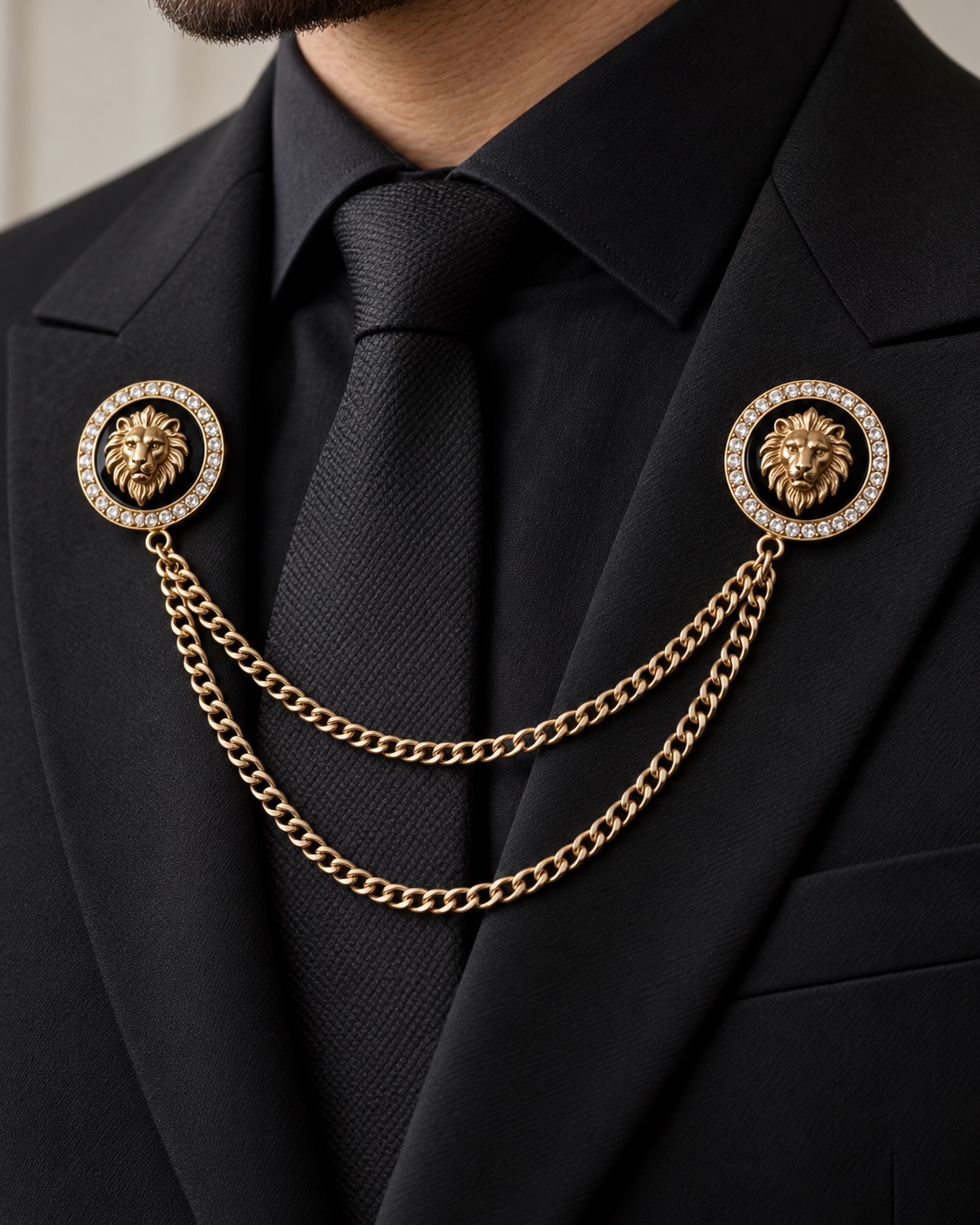 Two black and gold lion medallion pins joined by two draped chains